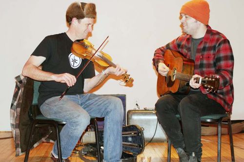 Teilhard Frost (fiddle) and Tom Power (guitar) warm up before the Maberly Quarterly square dance Saturday night in Maberly. Photo/Craig Bakay